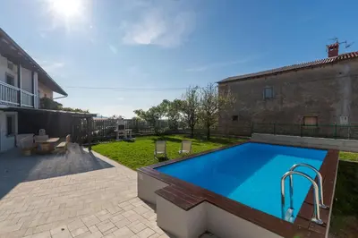 a swimming pool in the backyard of a house at Vila Sistiana in Kostanjevica na Krasu