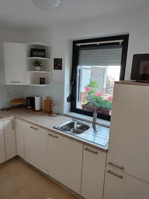 a small kitchen with a sink and a window at Apartma Nena in Bovec