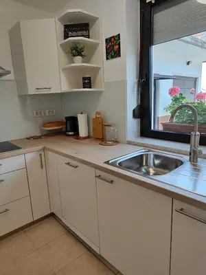 a kitchen with a sink and a window at Apartma Nena in Bovec