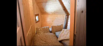 a small room with two chairs and a couch at Koča Velika Planina - Chalet Kamrica in Stahovica