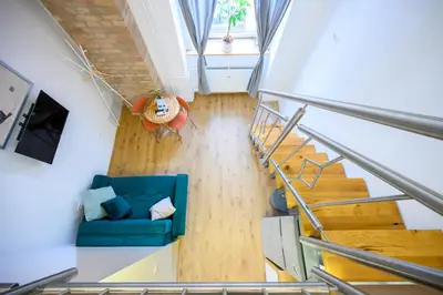 an overhead view of a living room with a blue couch at The Amazing Loft in Ljubljana