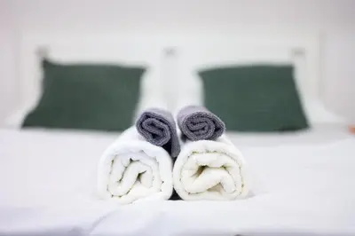 a pile of towels sitting on top of a bed at The Amazing Loft in Ljubljana