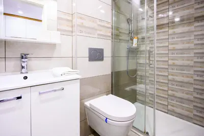 a bathroom with a toilet and a glass shower at The Amazing Loft in Ljubljana