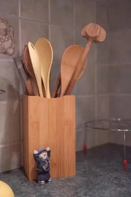 a wooden knife block filled with wooden utensils at House Banovci in Banovci