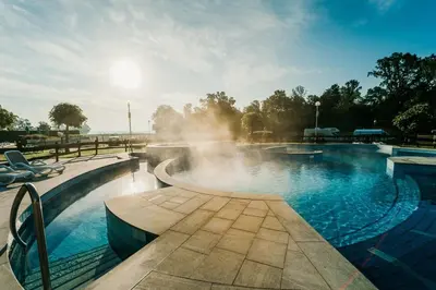 a swimming pool with a fountain in the middle at House Banovci in Banovci