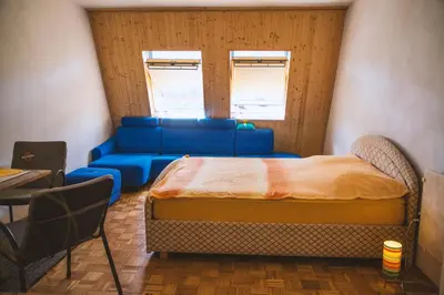 a room with a bed and a couch at Sončni apartma in Bovec