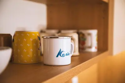 a coffee cup sitting on a wooden shelf at Sončni apartma in Bovec