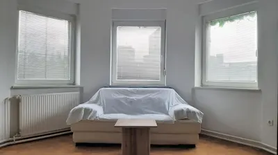 a bedroom with a bed and two windows at ROOMserv in Ljubljana