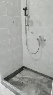 a shower with a hose in a bathroom at ROOMserv in Ljubljana