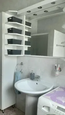 a bathroom with a sink and a mirror at ROOMserv in Ljubljana