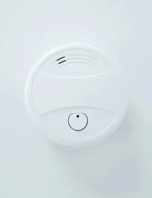 a white ceiling light on a white wall at ROOMserv in Ljubljana
