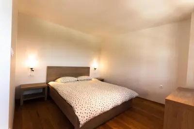 a bedroom with a bed and two night stands at Vinoteka Brda in Šmartno