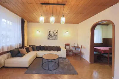 a living room with a couch and a table at Papas Apartment in Lesce