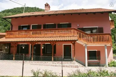 a house with a deck on top of it at House Maharac with 3 apartments till 15 persons in Kamno