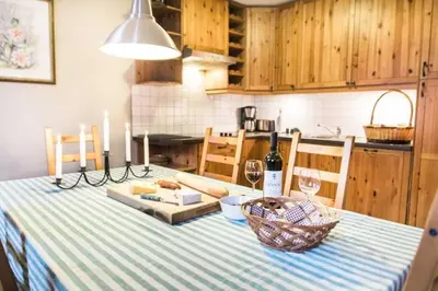 a kitchen with a table with a bottle of wine at House Maharac with 3 apartments till 15 persons in Kamno