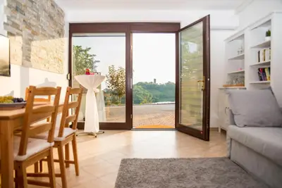 a living room with a table and a couch at Valentina Guest House at Pintar Wine Estate in Kojsko