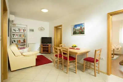 a living room with a table and chairs and a television at Valentina Guest House at Pintar Wine Estate in Kojsko