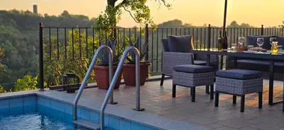 a patio with a table and chairs next to a pool at Valentina Guest House at Pintar Wine Estate in Kojsko