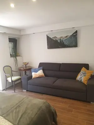 a living room with a couch and a table at Apartma na klancu in Kobarid
