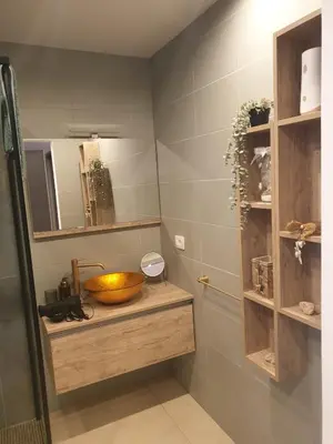 a bathroom with a sink and a bowl on a counter at Apartma na klancu in Kobarid