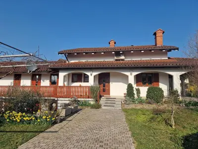 a large white house with a pathway in front of it at Merlin in Renče