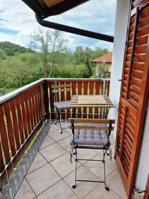 a balcony with a table and a chair on it at Merlin in Renče