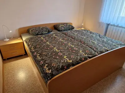 a bed with two pillows on it in a bedroom at Merlin in Renče