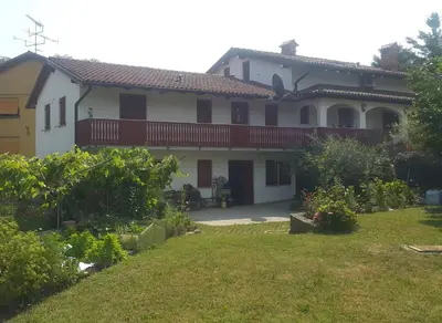 a house with a garden and a yard with a yard at Merlin in Renče