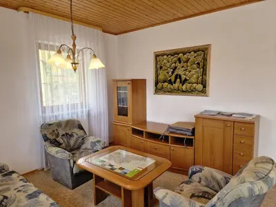 a living room with a table and chairs at Merlin in Renče