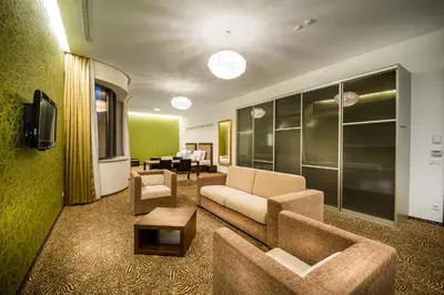a living room with a couch and a table at Rimske Terme Resort - Hotel Rimski dvor in Rimske Toplice