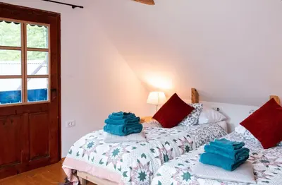 a bedroom with two beds and a window at Riverview Lodge in Bohinj