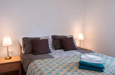 a bedroom with a bed with two lamps and two pillows at Riverview Lodge in Bohinj