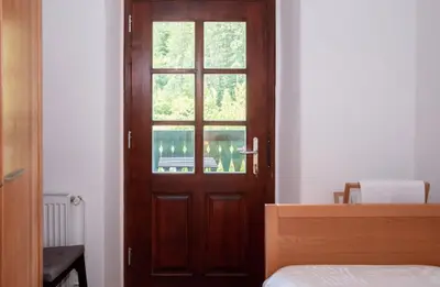 a wooden door with a window in a bedroom at Riverview Lodge in Bohinj