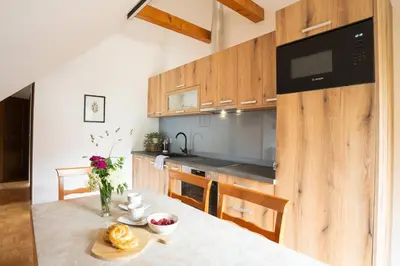 a kitchen with a table with a bowl of food on it at View apartment Lenart in Bohinj