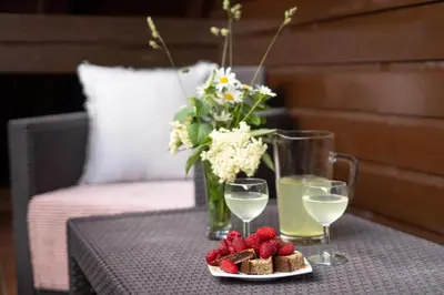 a table with a plate of food and glasses of wine at View apartment Lenart in Bohinj