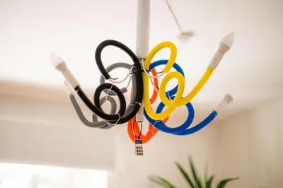 a group of olympic rings hanging from a ceiling at Art House Radovljica in Radovljica