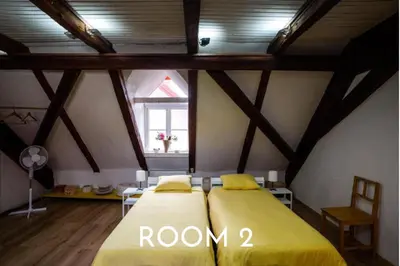 a bedroom with a yellow bed in a attic at Art House Radovljica in Radovljica