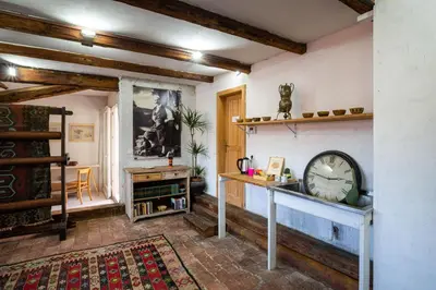 a living room with a clock on a wall at Art House Radovljica in Radovljica
