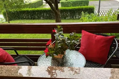 two vases sitting on a table with red pillows at Lanima in Bled