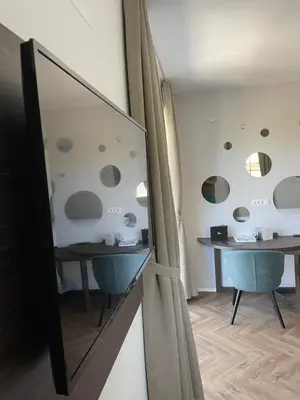 a room with two tables and a mirror at Design & Wine Vila Special Bled in Bled