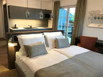 a bedroom with a bed with white sheets and pillows at Design & Wine Vila Special Bled in Bled