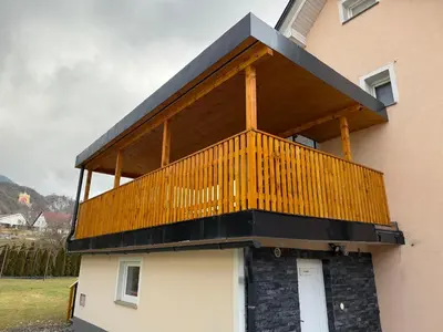 a balcony on the side of a building at Apartments Malivojevič in Žirovnica