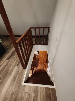 a staircase in a room with wooden floors at Apartments Malivojevič in Žirovnica