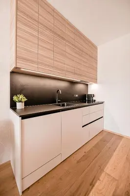 a kitchen with white cabinets and a sink at Sodoben apartma v centru Ljubljane in Ljubljana