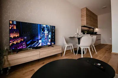 a living room with a large flat screen tv at Sodoben apartma v centru Ljubljane in Ljubljana