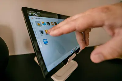 a person is pointing at a tablet computer screen at Sodoben apartma v centru Ljubljane in Ljubljana