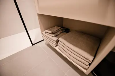 a small closet with folded towels in it at Sodoben apartma v centru Ljubljane in Ljubljana