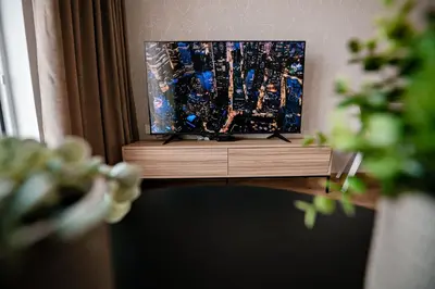 a flat screen tv sitting on top of a wooden stand at Sodoben apartma v centru Ljubljane in Ljubljana