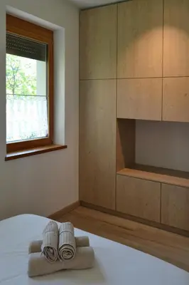 a bedroom with a bed with two towels on it at APARTMA VODNIK in Bohinj