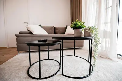 two black tables in a living room with a couch at Apartma 2+2 v mestu Ljubljana (V325) in Ljubljana